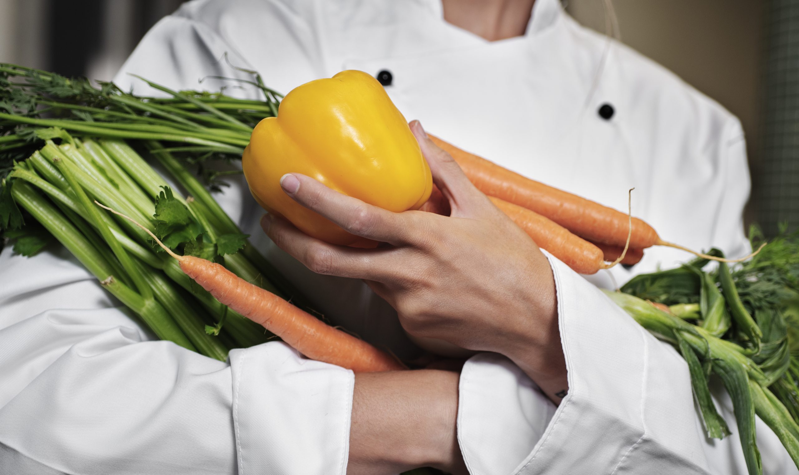 female-chef-kitchen-holding-vegetables (1)