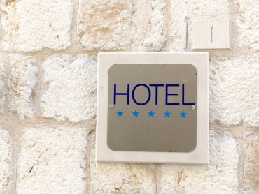 Closeup shot of five star hotel sign on old town wall